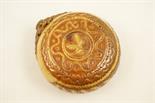 Continental treacle glazed pilgrim flask, carved slip decoration of trailing leaves, 19cm diameter