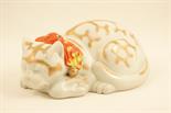 Japanese Kutani model of a sleeping cat, decorated in colours and gilt against a white ground, 28cm