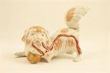 Japanese Kutani Pekingese dog, decorated in terracotta and splashes of gold against a white