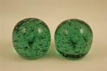Pair of early Victorian green glass dumps, each punctuated with a myriad of air bubbles around a