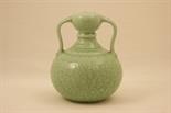 Chinese carved celadon bottle vase, having handles emerging from the neck to a globular body and