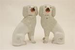 Pair of Staffordshire poodles, circa 1870, decorated with applied grog pieces, painted facial