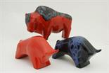 Lava pottery bison, decorated in an ashen and bright red glaze, 30cm, also two further lava glazed