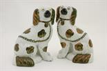 Pair of Victorian Staffordshire spaniels, circa 1880, moulded with free standing front leg,