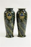 Matched pair of Royal Doulton stoneware vases, slender ovoid form decorated in low relief with