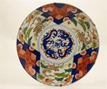 Japanese Imari plaque, Taisho (1912-26), decorated with cranes flying amidst pines in coloured