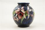 Moorcroft Orchid globular vase, with deep blue ground, impressed facsimile signature and blue