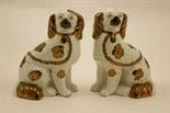 Pair of Victorian Staffordshire pottery spaniels, decorated with copper lustre splashes, height 23.