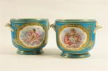 Pair of Sevres bleu celeste wine coolers, each decorated with a reserve featuring winged cherubs