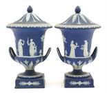 Pair of Wedgwood dark blue jasper lidded urns, each decorated with classical figures in low relief,