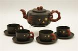 Chinese Yixing tea service comprising lidded teapot, squat circular body decorated with prunus