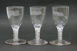 Three Georgian style opaque airtwist glasses, ovoid bowl over a short spiral and gauze twist stem