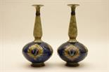 Pair of Royal Doulton stoneware bottle vases, Persian inspired shape decorated with foliate reserves