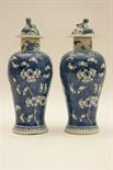 Pair of Chinese prunus blossom lidded vases, late 19th Century, with domed covers (chips), painted