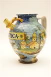 Cantagalli maiolica wet drug jar, decorated in the Italian tin glazed tradition with a winged cherub