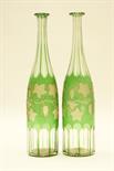 Pair of Bohemian green overlay engraved glass decanters, engraved with trailing vines (no stoppers),