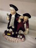 STAFFORDSHIRE POTTERY; Polychrome decorated group of 2 night revellers, 9.5" high