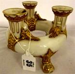 ROYAL WORCESTER; gilded ivory ware triple necked flower holder on gilt foliate feet (some edge