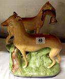 STAFFORDSHIRE POTTERY; pair of late Staffordshire figures of hunting dogs and game (slight defects),