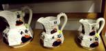 WELSH POTTERY; three graduated serpent handled 19th century octagonal jugs, polychrome decoration