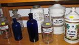PHARMACIST JARS, a collection of 9 glass and ceramic pharmacist jars, some with original labels