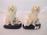 STAFFORDSHIRE POTTERY, Two 19th Century royal blue base seated encrusted spaniels and puppies,