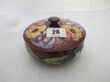 MOORCROFT, ``Pansy`` pattern red ground circular lidded bowl