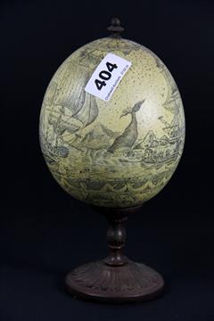 A Mounted And Scrimshaw Decorated Ostrich Egg