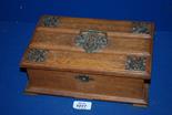 An Oak box with decorative brass corners and handle