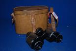 A leather cased pair of Binoculars by Lancaster and Thorpe Ltd.
