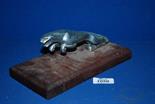 A Jaguar Car Mascot mounted on a wooden plinth