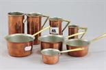 A Miniature Copper Saucepan Set and a Similar Set of Spirit Measures