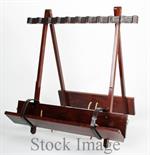 A TEAK PORTABLE FOLDING GUN RACK WITH LEATHER LINING AND BRASS MOUNTS suitable for ten guns