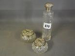 Three silver top cut glass dressing table jars
Condition report:  Cracks to large squat jar, some