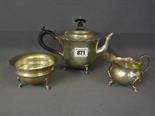 A silver Bachelor's teapot, a silver sugar bowl and cream jug - all differing designs, dates and