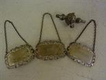 Three silver decanter spirit labels and silver part rattle - Total approx. weight 1.9 troy oz