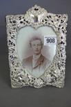 A very pretty Victorian silver photograph frame with an embossed and pierced decoration of