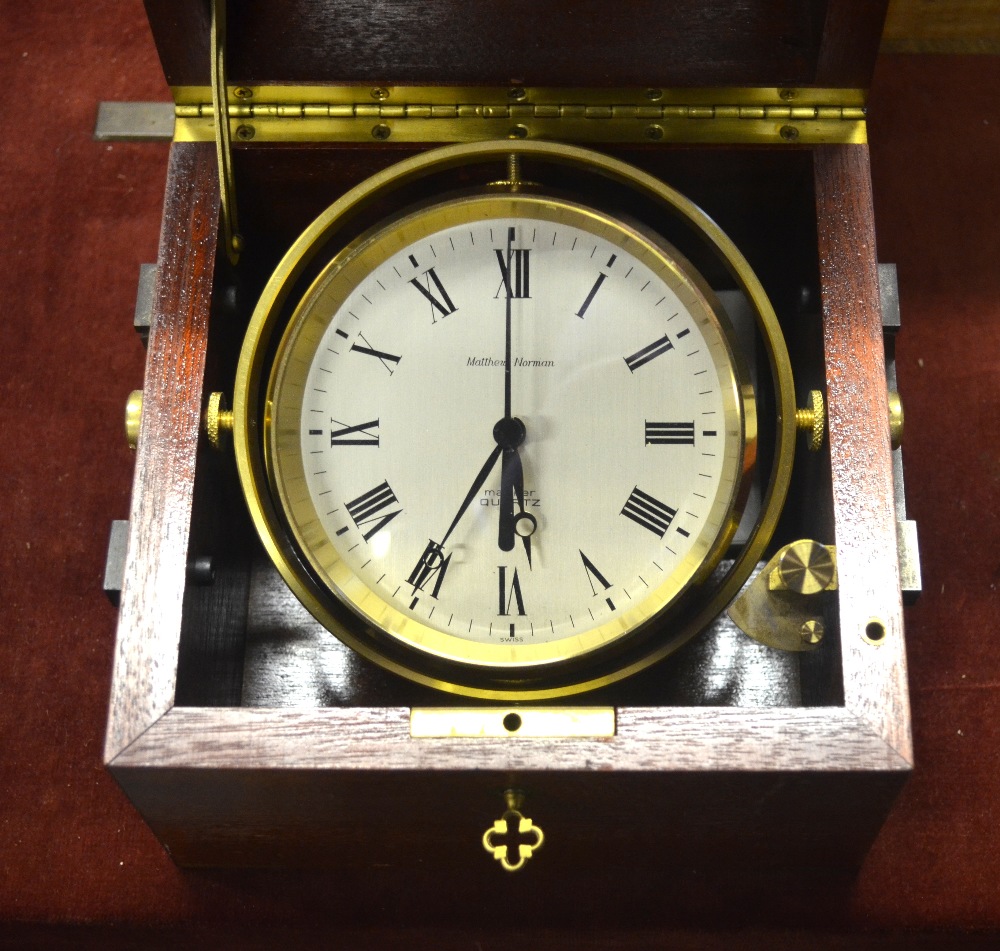 A brass Matthew Norman Mariner ship's clock with quartz movement, on
