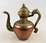 A Tibetan copper, brass and white metal teapot, the spout and handle having dragon details, 27 cm