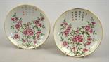 A pair of Chinese famille rose saucers decorated with blossom and calligraphy, six character seal