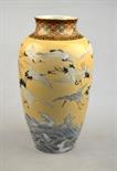 A Japanese baluster vase decorated with numerous red-capped cranes flying over breaking waves,