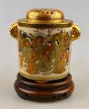 A Japanese Satsuma cylindrical jar and reticulated cover decorated with 16 immortals, Meiji, 12.5 cm