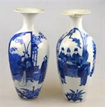 A pair of Chinese blue and white slim ovoid vases with flared necks, each decorated with figures