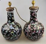 A pair of Chinese famille rose bottle vases decorated with butterflies on a black ground, 20th