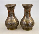 A pair of Persian brass baluster vases decorated in a traditional style with overlaid copper and