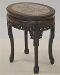 A Chinese oval hardwood low stand with inset marble top, having a frieze carved with fruit and