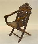 A Chinese carved hardwood folding chair carved with shou characters and dragons, early 20th century