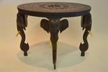 An Indian oval hardwood occasional table having a central circular cartouche carved with a