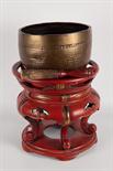 JAPANESE FLOOR STANDING PRAYER GONG with bronze bowl gong and striker, the round stand in red