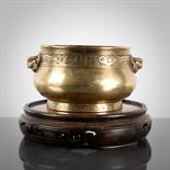 CHINESE BRONZE CENSER with mark to base and with four dog head handles, on a carved wooden stand,